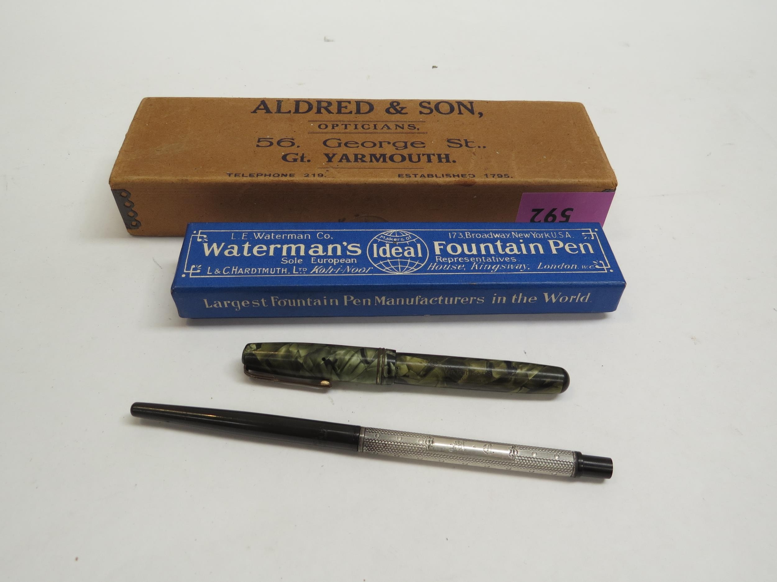 An early Watermans ebonite and silver cased Ideal fountain pen. The nib marked Watermans Ideal New