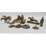 A box containing decorative brassware including fox, racing horses and miner figure