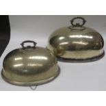 Two Victorian silverplate domed meat covers, one with substantial dents, 46.5cm long and 37cm long
