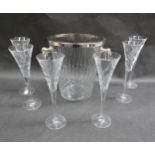 A set of six crystal glass champagne flutes and a similar champagne bucket