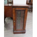 A Victorian walnut round-cornered pot cupboard, the single door with textile panel, plinth base,