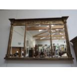 A gilt pier mirror with three bevelled glass panels, acanthus scroll decoration, column supports,