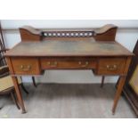 An Edwardian lady's writing desk with twin letter compartment cupboards to top, leather inset