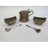 A Chester silver mustard (marks rubbed) and a pair of silver salts with embossed floral detail,