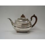 An Alice and George II silver teapot raised on four ball feet, London 1810, 461g