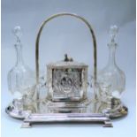 A Victorian plated decanter stand with integrated ice bucket, two decanters with stoppers engraved