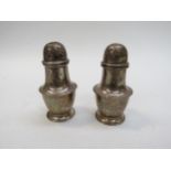 A pair of silver pepperettes, marks rubbed, 7.5cm tall, 61g