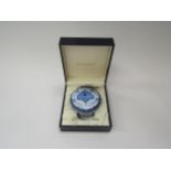 A cased Moorcroft Enamel circular trinket box with Blue Poppy design, 7.5cm diameter