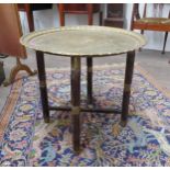 A turn of the 20th Century brass topped Indian table with folding base, campaign styling, 60.5cm
