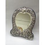 A Victorian Goldsmiths & Silversmiths Co. silver easel back table-top mirror of heart form, ornate