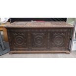 A 17th Century carved oak coffer, three panel front with roundel design, 60cm x 128cm x 54cm