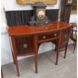 A late 19th Century mahogany bow-front sideboard with brass curtain back rail, two cupboards,