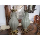 A pair of 19th Century French porcelain covered vases with ormolu mounts and base, possibly