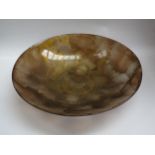 A glass shallow form dish in autumnal colours, 51cm diameter