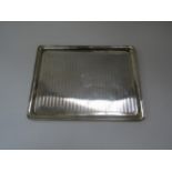 A silver rectangular tray, vacant cartouche, engine turned line decoration. Chester marks rubbed,