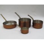 A set of four French copper saucepans of varying sizes with cast metal handles, smallest 9cm
