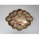 An early 19th Century Crown Derby Imari palette dessert dish of scalloped oval form, 24cm x 30cm