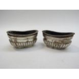 A pair of George Unite silver melon fluted salts with blue glass liners, Birmingham 1902, 4cm x 7.