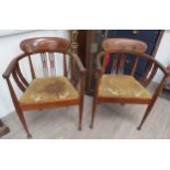 A pair of Edwardian mahogany tub chairs with Arts & Crafts styling (3 cross mark to base front