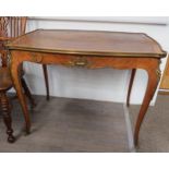 A 19th Century French kingwood writing table, the tooled brown leather top over an ormolu mounted