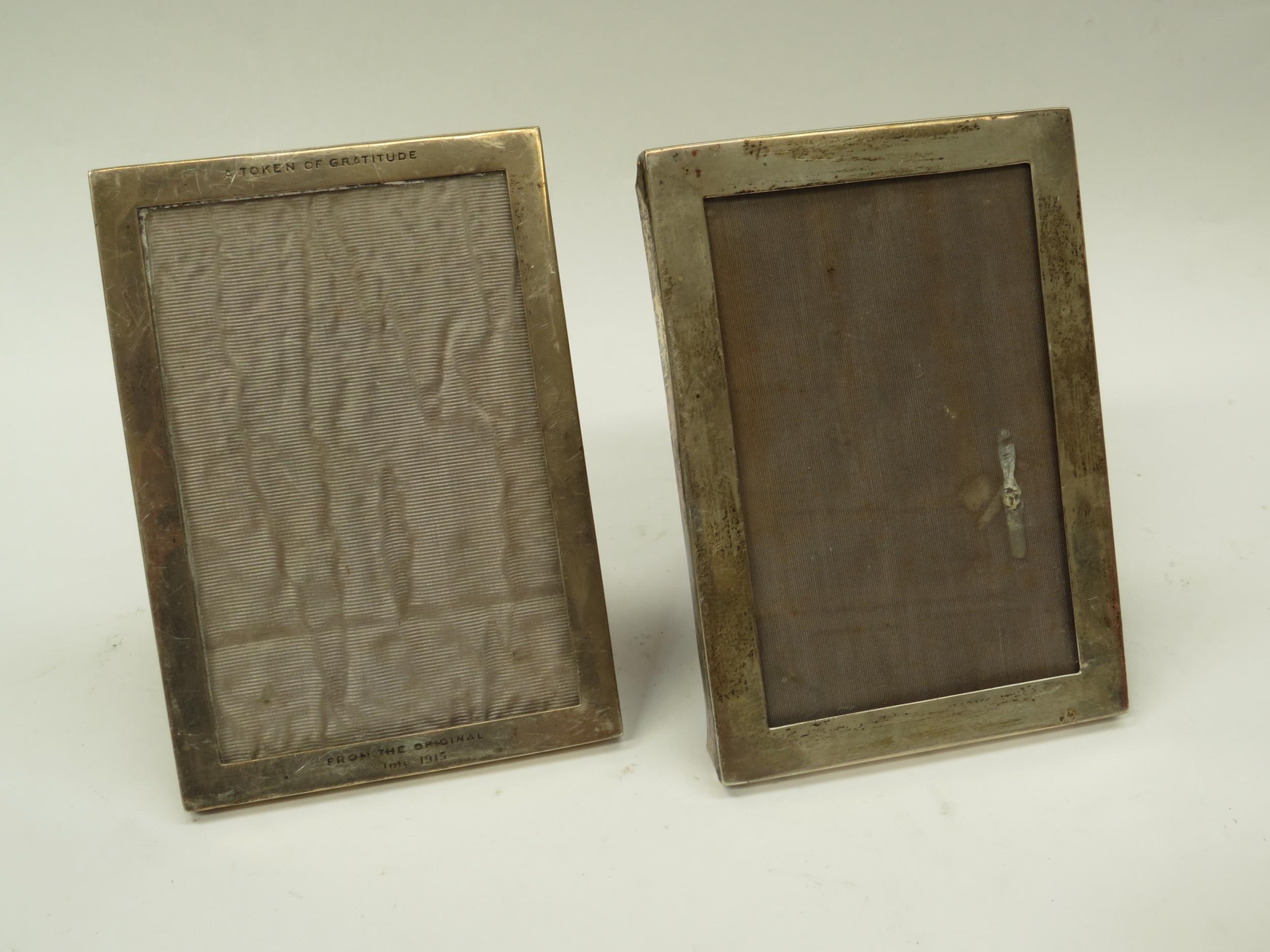 A near pair of William Neale silver photograph frames, one with inscription "A token of gratitude