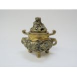 A cast bronze lidded koro with dragon and dog of fo design on four feet, 11.5cm tall