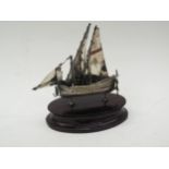 A Maltese silver model of a sailing boat marked 917 on ebonised plinth, 11cm tall x 9cm long