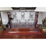 A 20th Century mahogany lockable three bottle tantalus with Royal Doulton crystal decanters 39.5cm