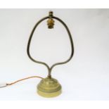 A vintage brass lamp with central drop bulb fixture