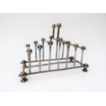 A Christopher Dresser style silver plated seven bar toast rack