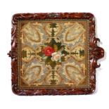 A Victorian needlepoint tapestry, urn with flowers, Gothic style surround framed in an ornately