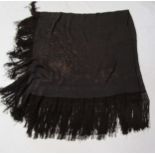 Two black silk shawls, one has a black embroidered pattern of flowers to the outer edge
