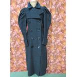 An early 1970's black boucle wool lady's full length coat, exquisitely crafted and sculptured manner