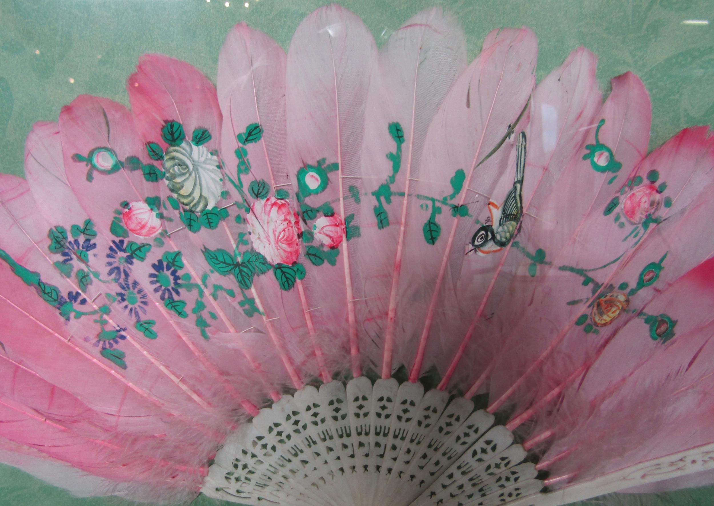 A mounted and framed display of two hand fans, one of fine gauze with hand-painted flowers in lilac, - Image 2 of 3