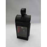 A black painted three aspect handlamp with red and clear aspects, copper resevoir and brass and
