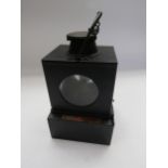 A black painted signal lamp interior with brass burner, copper plaque stamped Gorleston Nth, with