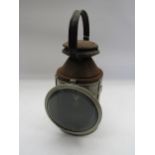 A LMSR three aspect handlamp with reservoir, burner and reflector plate, stamped L&NWR Gar Dept,