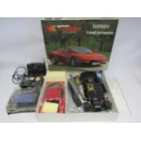A part built System Robbe #3748 Ferrari Testarossa 1:10 scale remote control car model kit (contents
