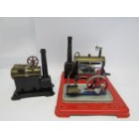 Two Mamod live steam stationary engines, each with a brass horizontal boiler, cast metal chimney,