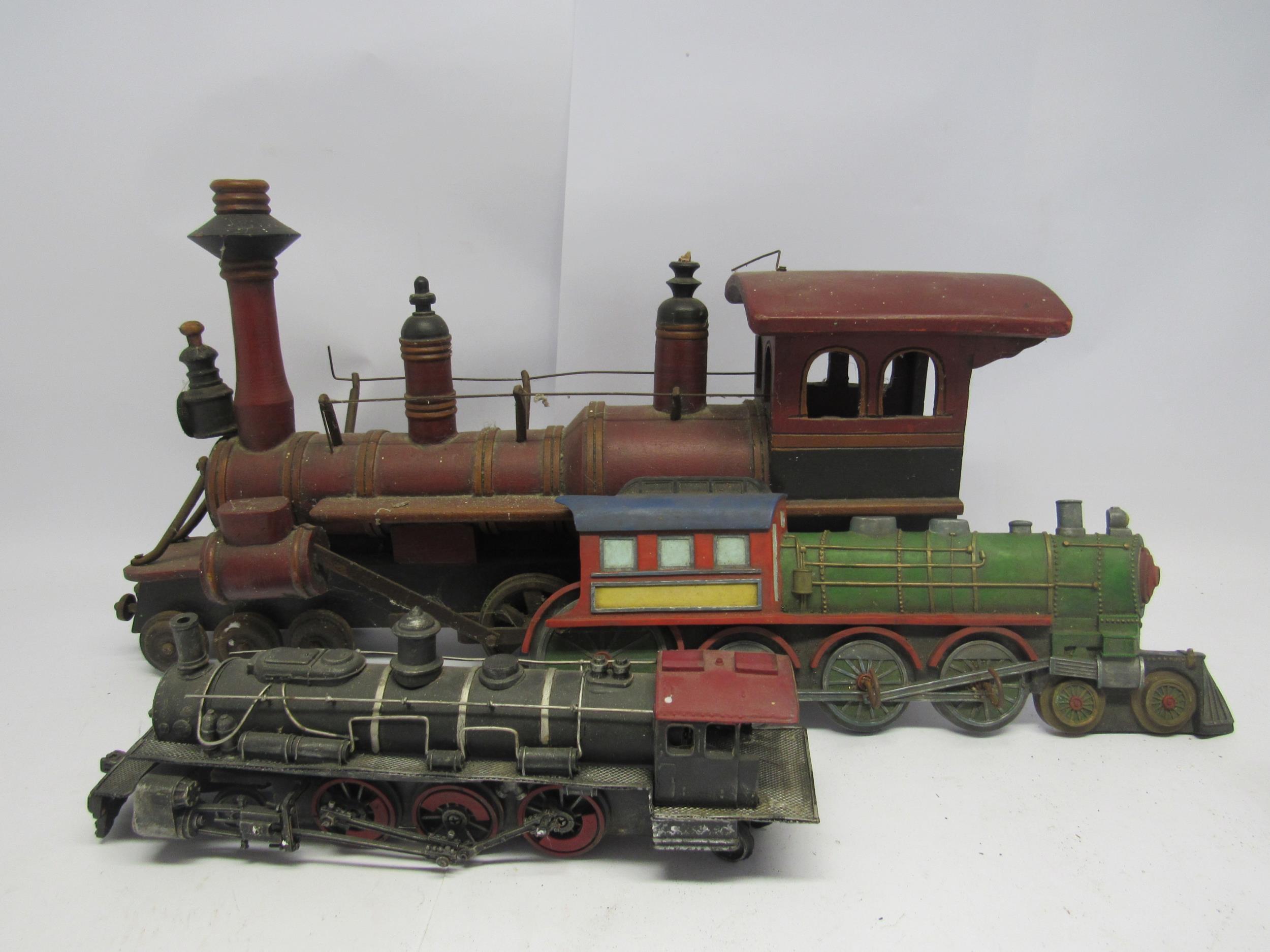 A wooden model American style locomotive, 60cm long, together with a smaller metal example and a