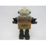 A Horikawa, Japan, battery operated tinplate and plastic piston robot, 26cm tall
