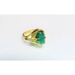 A gold ring of modernist form set with rough cut emerald. Size J, 4.6g