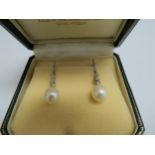 A pair of white gold diamond and pearl drop earrings stamped 375, 3.8cm drop, 4.3g