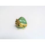 A gold pendant/charm with a heart shaped jade centre in scroll work mount, marks rubbed, 9.4g total