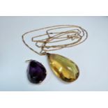 A large facet pear cut citrine pendant stamped 9ct, 5.5cm long hung on a gold chain, 142cm long,