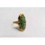 A gold carved moss jade dress ring, wavy edge mount, stamped 585. Size T, 3.6g