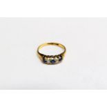 A diamond and sapphire ring, stamped 18ct. Size M, 2g