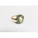 An Art Deco gold ring centrally set with an irregular shaped pearl framed by diamonds. Size R, 3.1g