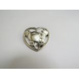 A Georg Jensen sterling silver brooch depicting a bird with open wings in foliage, designed by
