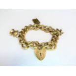 A 9ct gold heavy link charm bracelet with padlock clasp, 70.6g